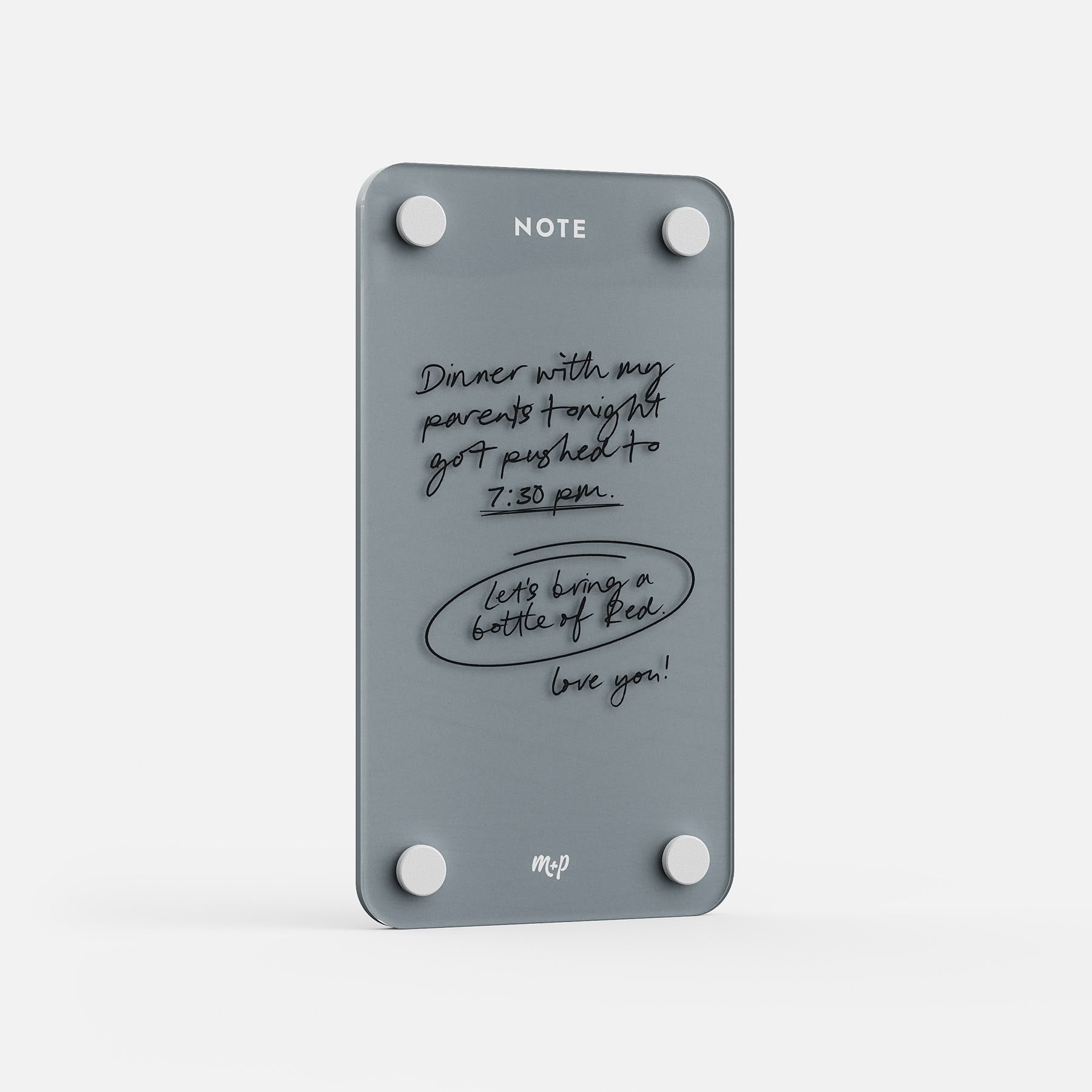 Angled view of a Slate grey tall magnetic acrylic note board with a handwritten note to a partner